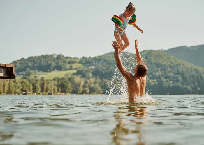 Family playing in the water of Lake Stubenberg in Eastern Styria